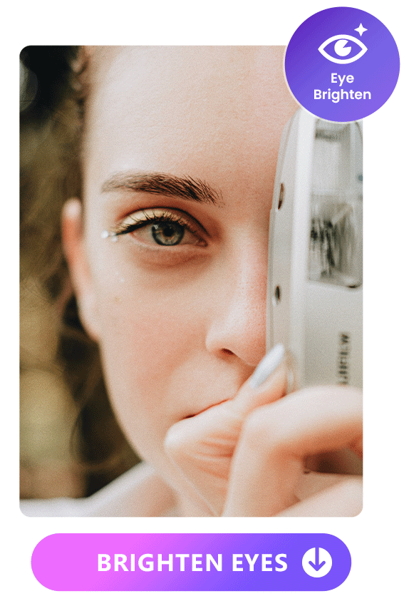 enhance the eye of a girl holding a camera by brightening the eye with Vivid Glam